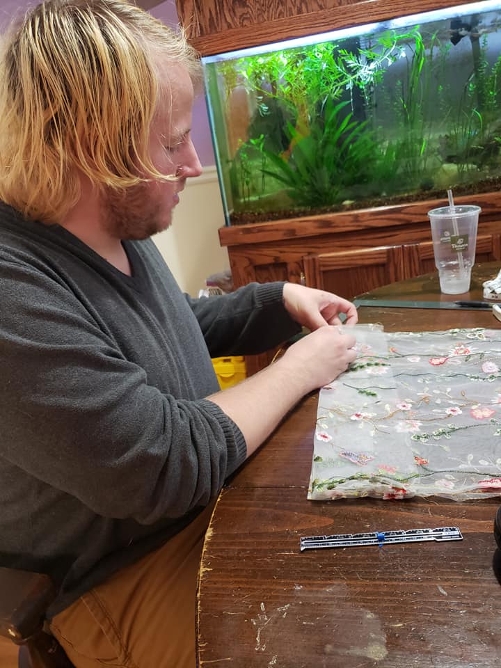 Austin and Isabel sewing some curtains for their kitchen